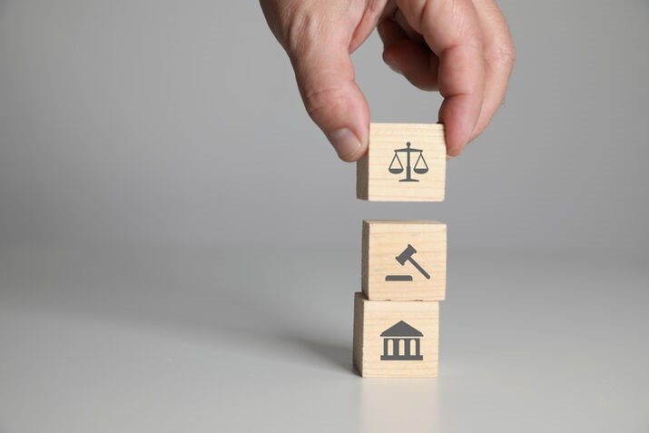 A hand stacking wooden blocks with symbols

AI-generated content may be incorrect.